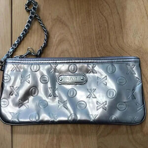 XOXO silver vinyl wristlet with zippered close.